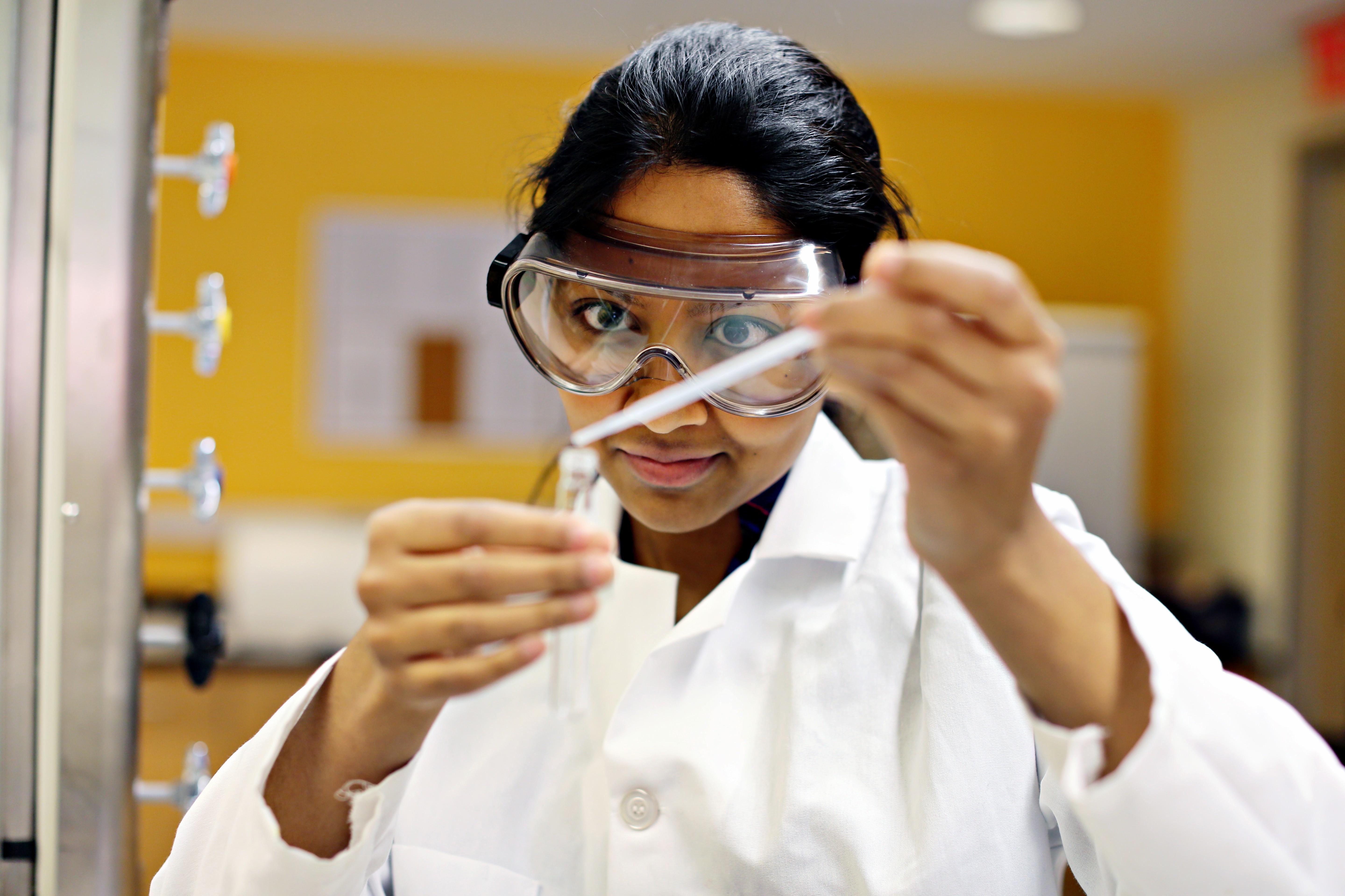 Student using pipette in a lab