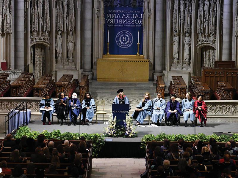 Wide photo of Laura Rosenbury speaking from the dais at Riverside Church at her inauguration as president of Barnard.